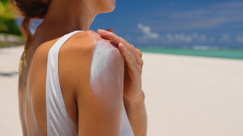 A woman applying sunscreen