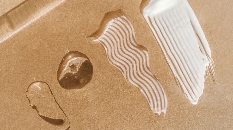Different skincare products spread on brown surface