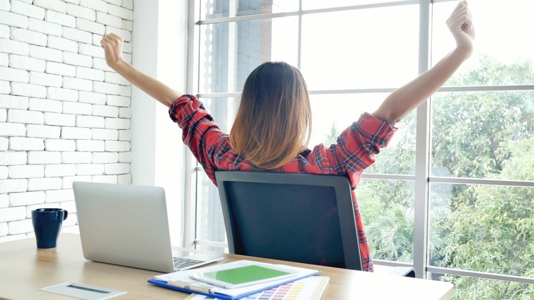 Woman stretching at her desk