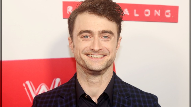 Daniel Radcliffe posing at the opening night of Stephen Sondheim's "Merrily We Roll Along" on Broadway at The Hudson Theater