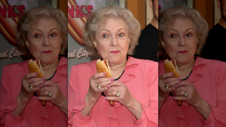 Betty White eating a hotdog