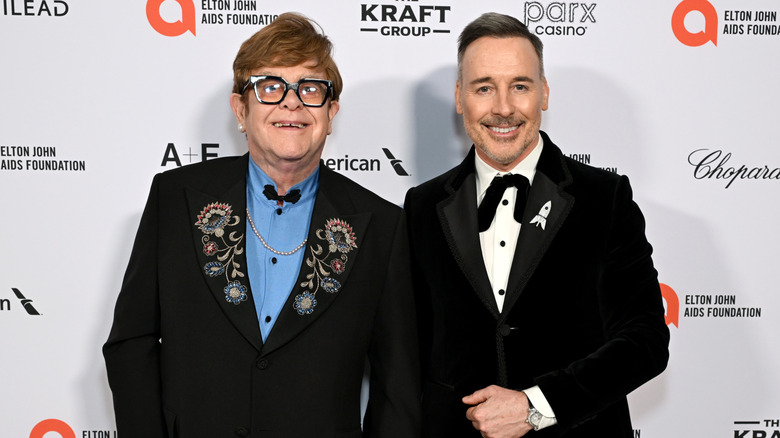 Elton John and David Furnish posing at a celebrity event