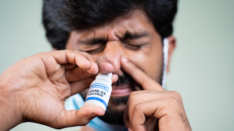 person inhaling covid vaccine
