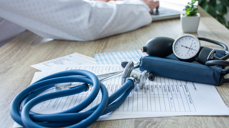 sphygmomanometer on desk next to laptop