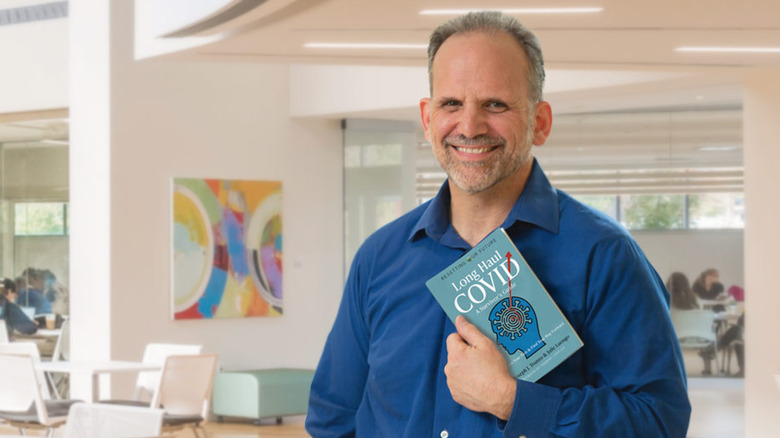 Dr. Joseph Trunzo holding his book 'Long Haul COVID: A Survivor's Guide'