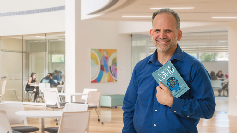 Dr. Joseph Trunzo holding his book
