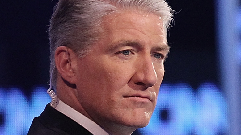 Close up on face of CNN anchor John King with CNN sign in background