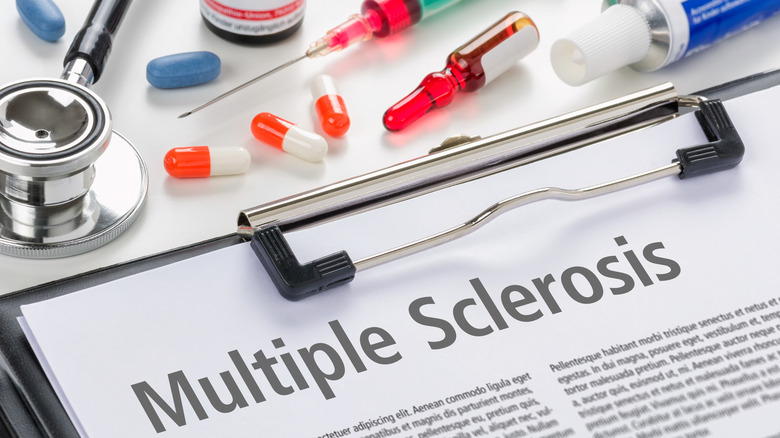Multiple sclerosis paperwork on desk surrounded by medications