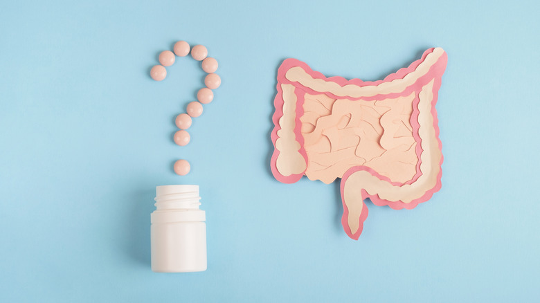 pills in question mark and digestive system