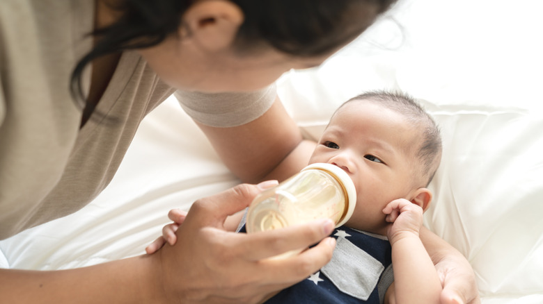 mom feeding baby formula