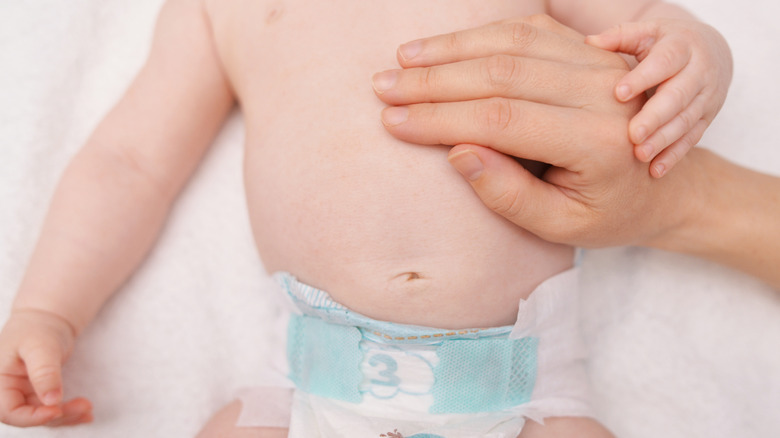 mom's hand on baby's stomach