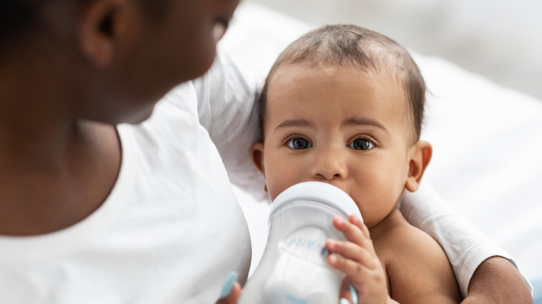 baby drinking milk from bottle