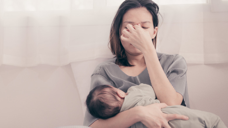 mom holding baby stressed
