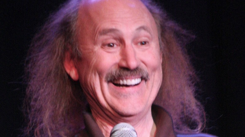 comedian Gallagher laughing onstage