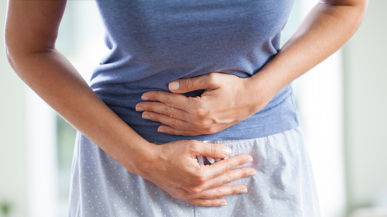 woman holding stomach