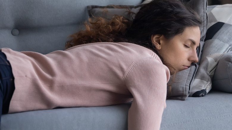 young woman resting on the couch lazily