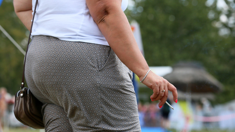 fat woman smoking a cigarette