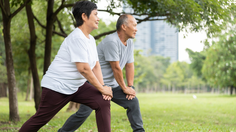 Older couple exercising outside