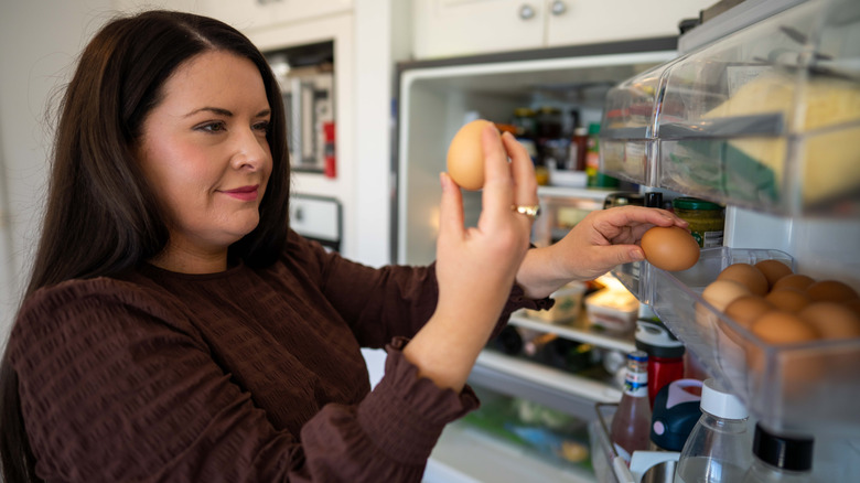 Woman taking eggs out of the refrigerator