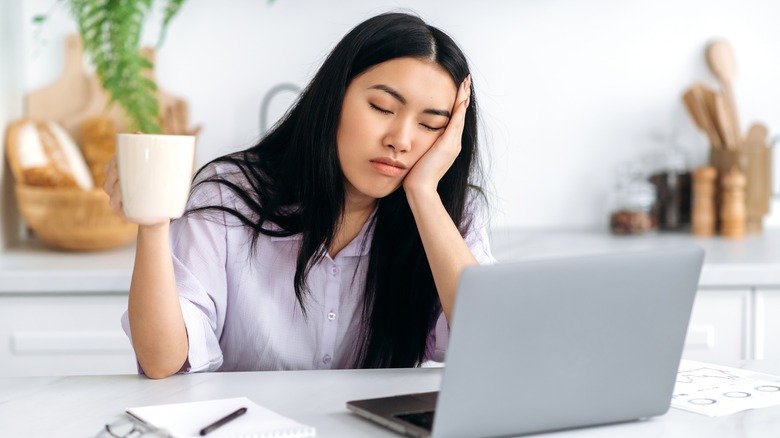 tired woman propping her head up