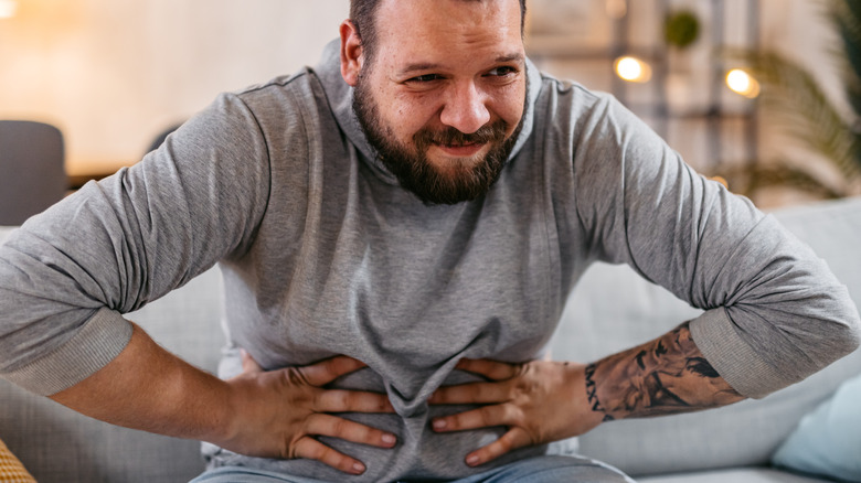 Man holding stomach in pain