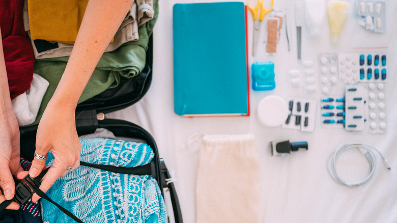 woman packing medications for trip