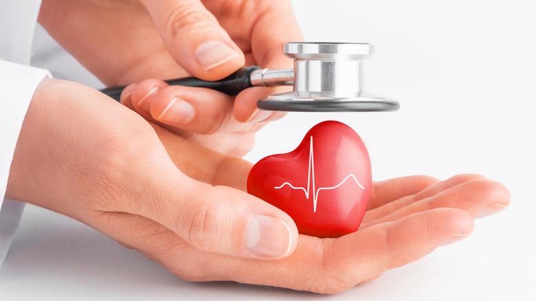 Stethoscope hovering over heart model