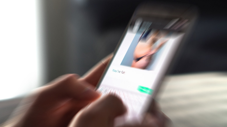 A phone screen with an image of a larger person