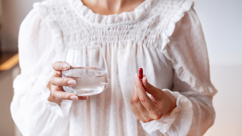 woman holding supplements