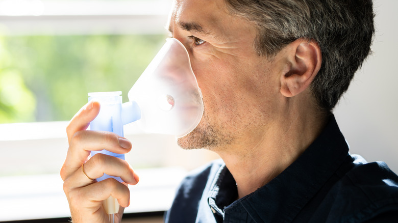 Man with COPD using nebulizer