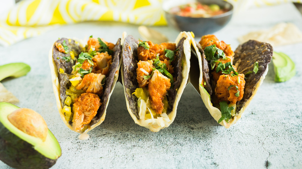 Tacos and burritos on a plate.