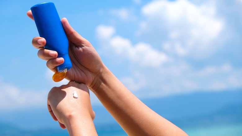 A person applying sunscreen