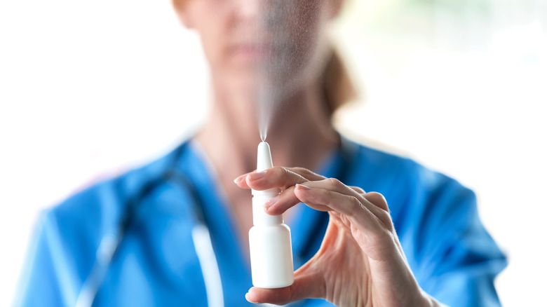 doctor spraying a close-up of a nasal spray