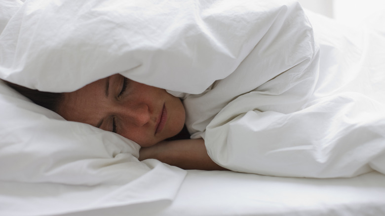 woman seeping under covers