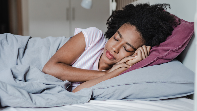 Woman sleeping soundly in bed