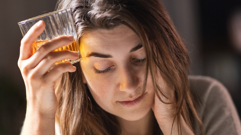 woman depressed while drinking alcohol