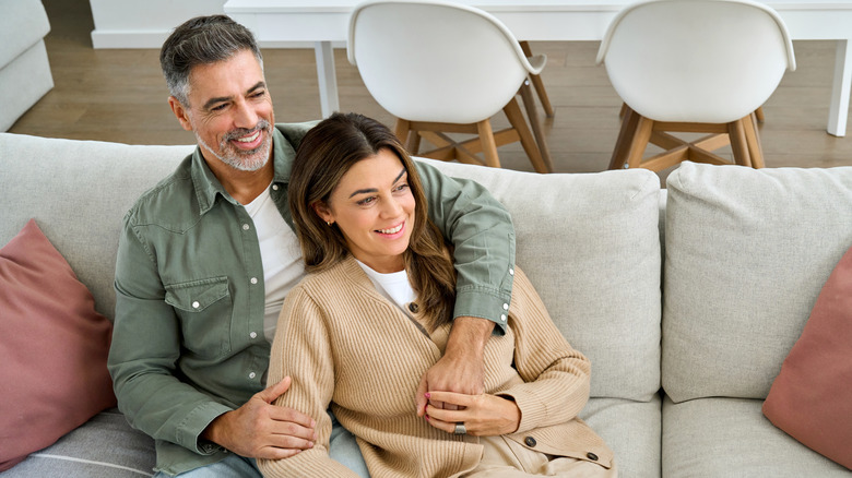 A healthy middle-aged couple sitting on the couch