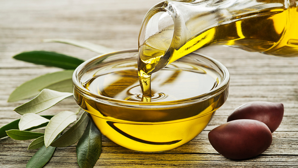 stock photo of a bottle of olive oil with olives