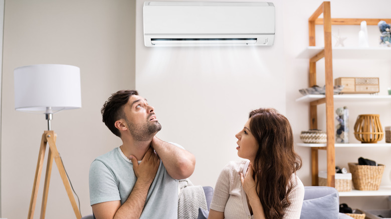 Couple holding sore throats