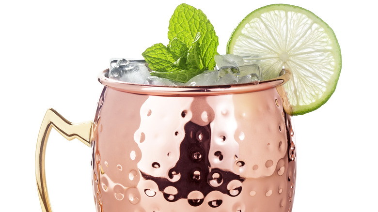 A Moscow Mule in a copper mug against a white background