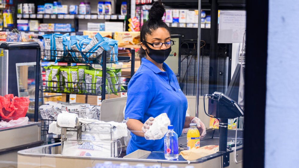 Grocery cashier rings up items