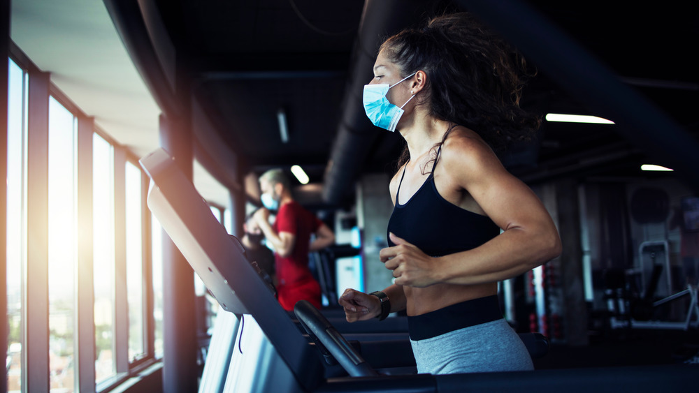 Woman exercising with mask on