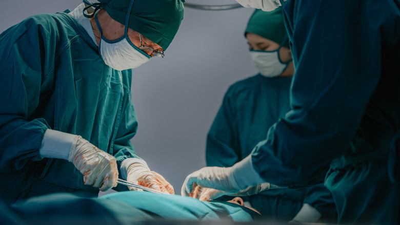 Surgeons performing a medical procedure in an operating room