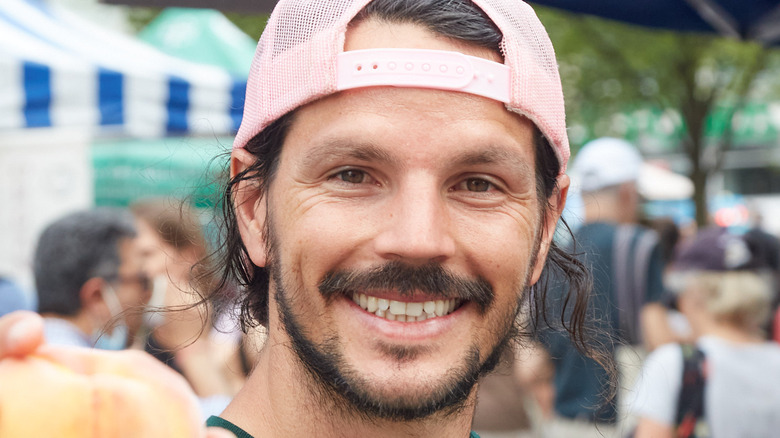 Dan Churchill smiling holding peach