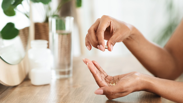 Woman's hands holding pills