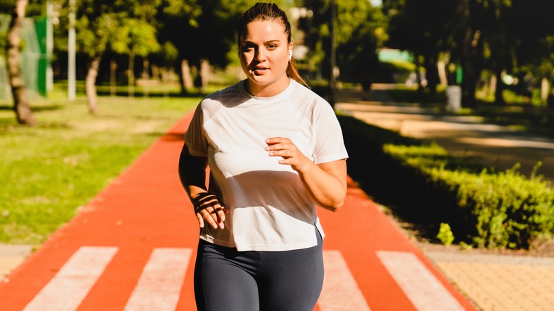 woman running track