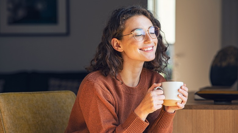 A woman enjoys a cup of coffee