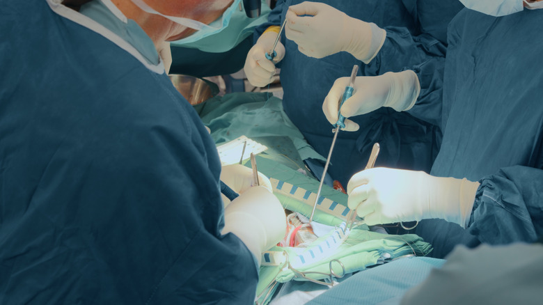 doctors in an operating room conducting surgery