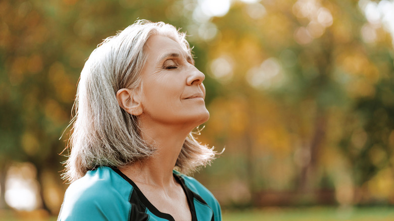 woman calming herself outside in nature