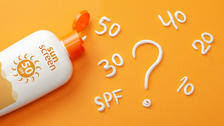 bottle of sunscreen with various SPFs on background